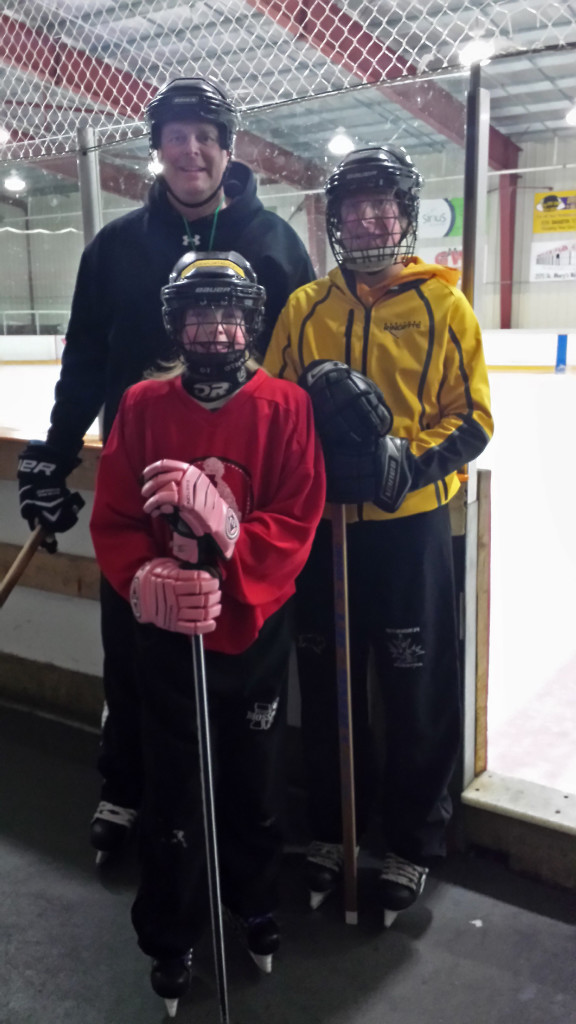 Bison employee playing hockey with daughters