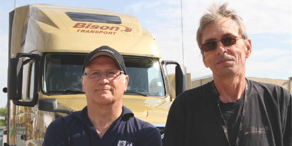 Bison drivers standing in front of truck