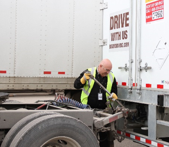 Driver hooking up LCV converter to semi trailer