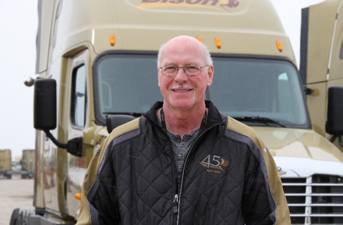 Truck driver standing in front of Bison Transport truck