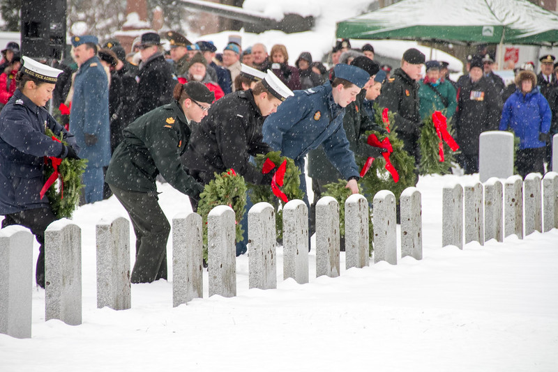 Youth laying wreathes in cemetery