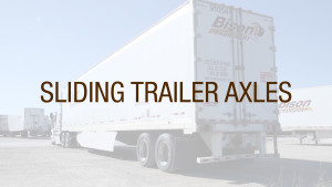 A truck driver sliding trailer axles