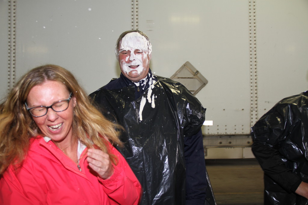 Employee throwing pie at managers face