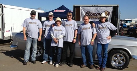 Pit crew in front of drag racing car