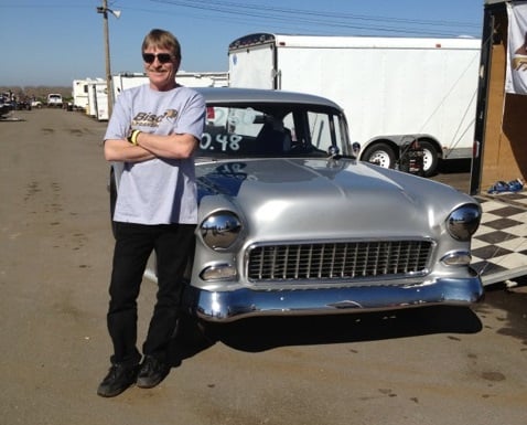 Randy Kuryk in front of drag racing car