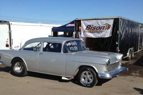 Drag racing car in front of Bison Transport flag