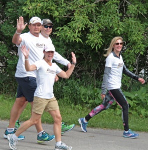 Sara (pink hat) joins Rob and several Bison team members at the Challenge for Life Walk!