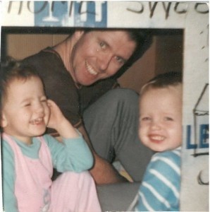 Sarah-Jane, in a home-made play house with her father and brother.